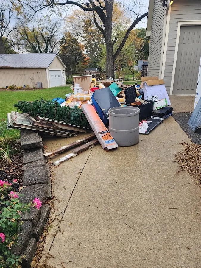 Dumpster being loaded with debris for Residential Dumpster Rental in Marshall